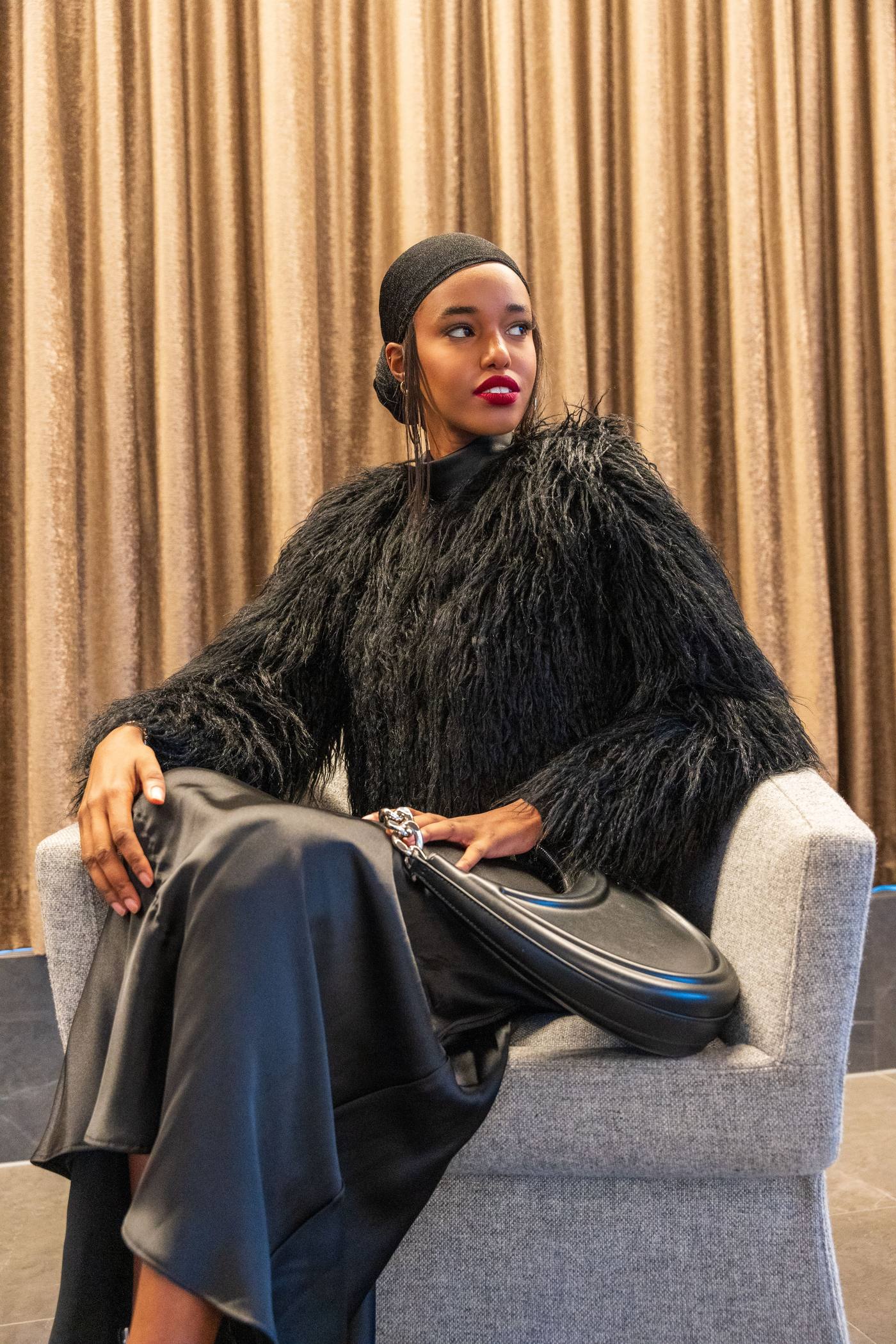 A woman sitting confidently